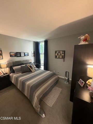 a bedroom with double bed and a flat screen tv