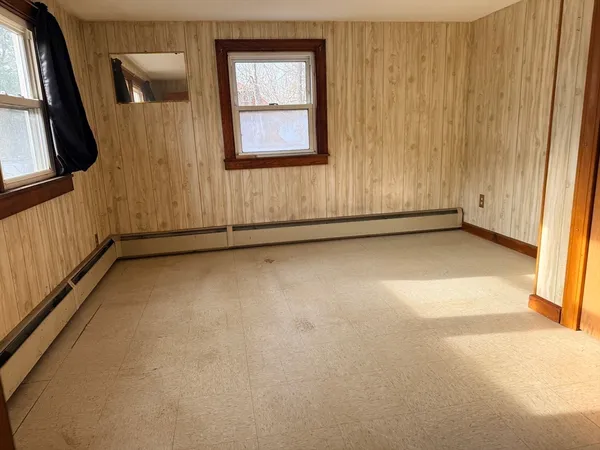 a view of a livingroom with wooden floor and a window