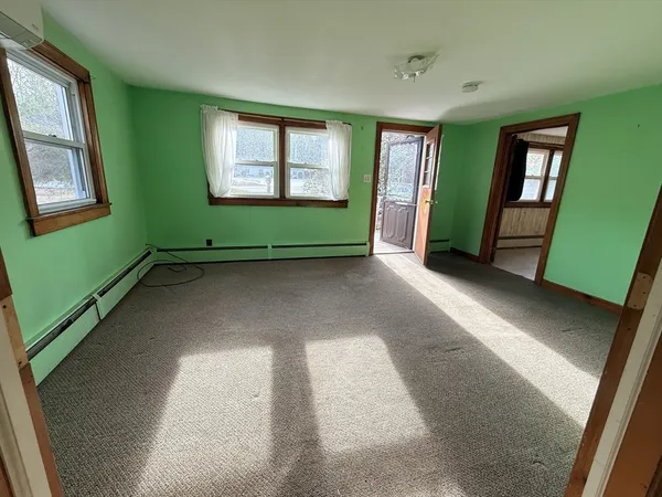 a view of empty room with window and fireplace