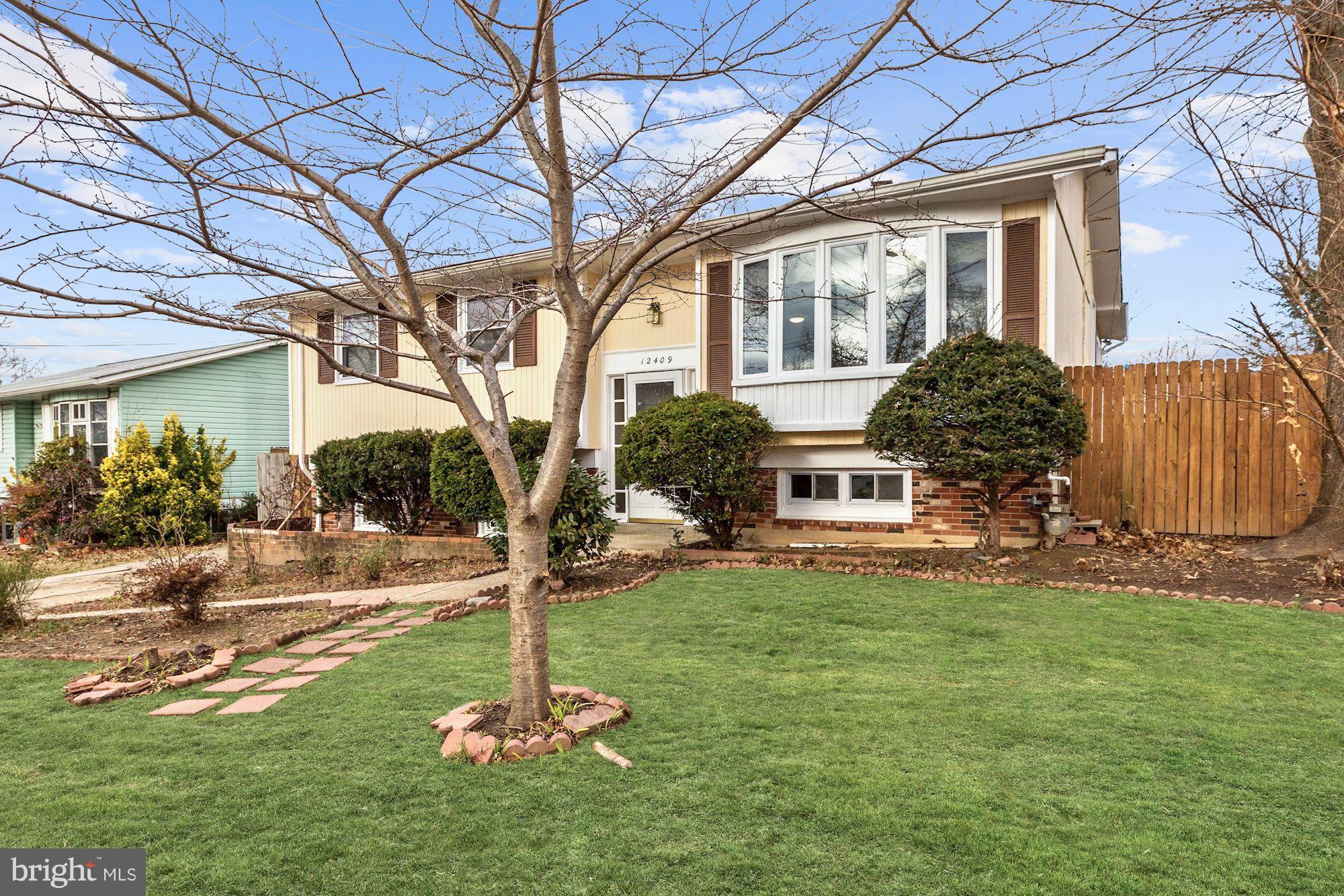 12409 Littleton Street Silver Spring, MD 20906 - Photo 2 of 31 a front view of a house with a yard