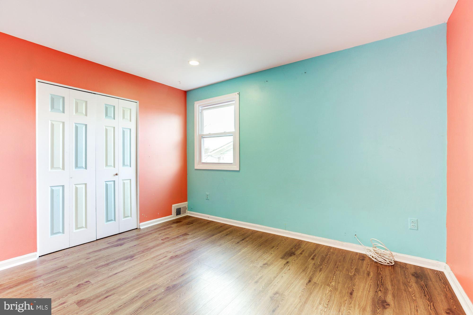 12409 Littleton Street Silver Spring, MD 20906 - Photo 14 of 31 an empty room with wooden floor and windows
