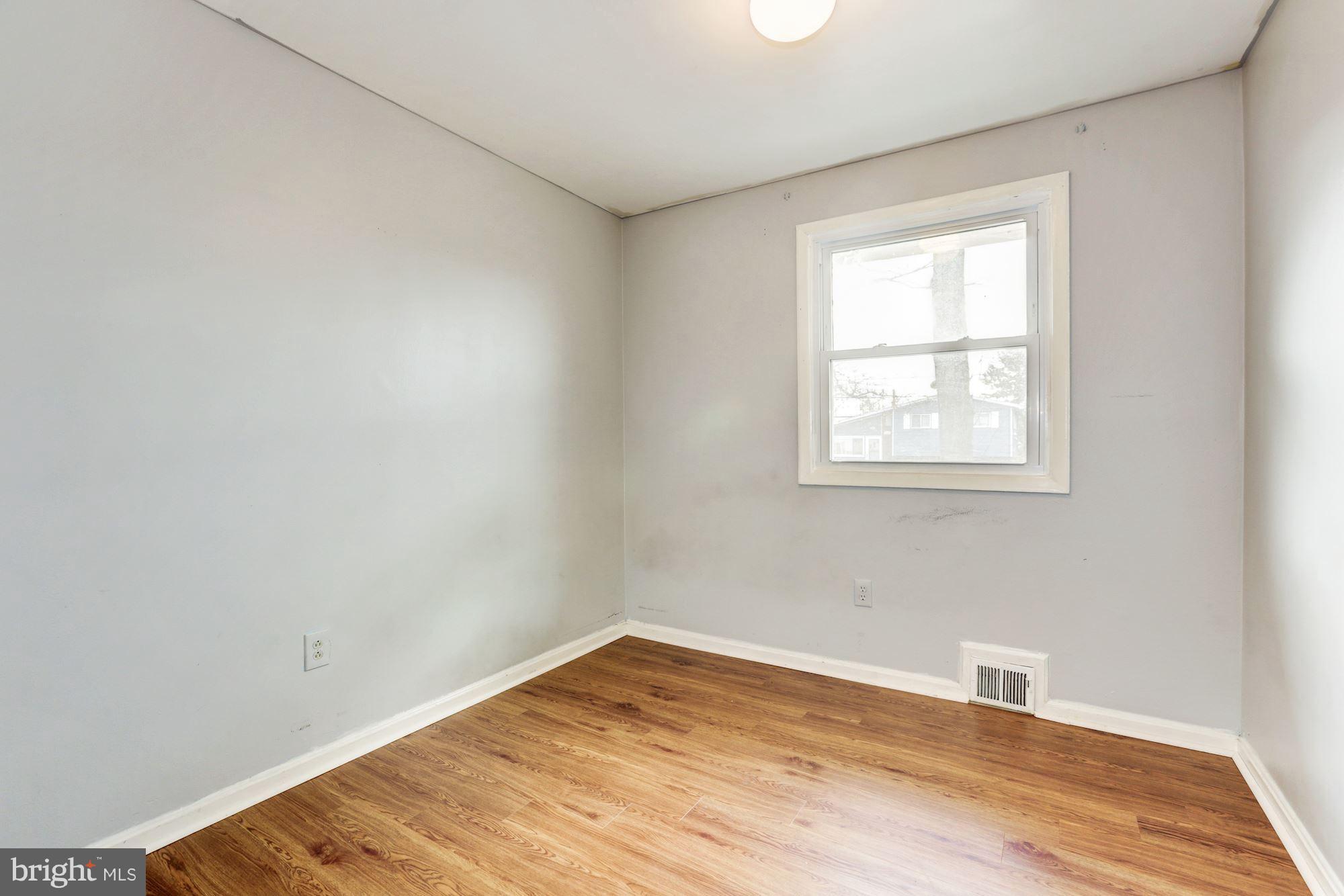 12409 Littleton Street Silver Spring, MD 20906 - Photo 15 of 31 an empty room with wooden floor and windows
