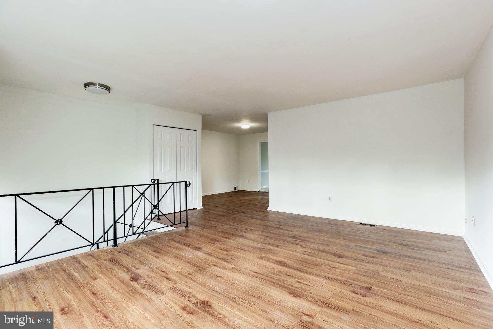 12409 Littleton Street Silver Spring, MD 20906 - Photo 5 of 31 a view of an empty room with wooden floor