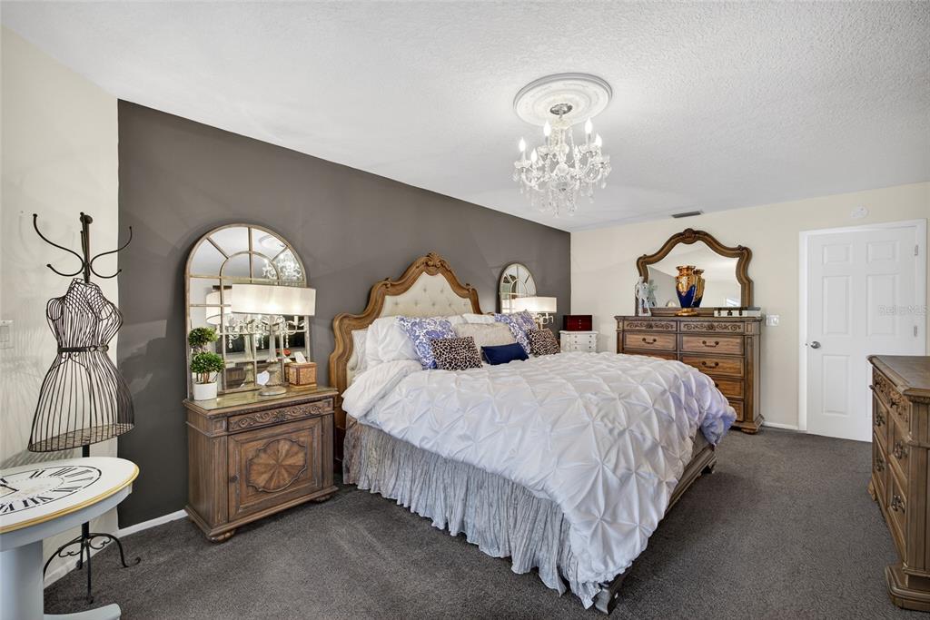 5061 San Rocco Court Punta Gorda, FL 33950 - Photo 11 of 32 a bed room with two beds and a chandelier