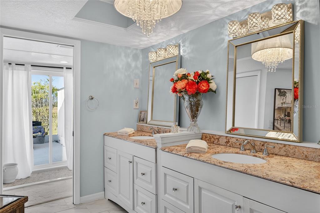 5061 San Rocco Court Punta Gorda, FL 33950 - Photo 12 of 32 a bathroom with a granite countertop sink and a mirror
