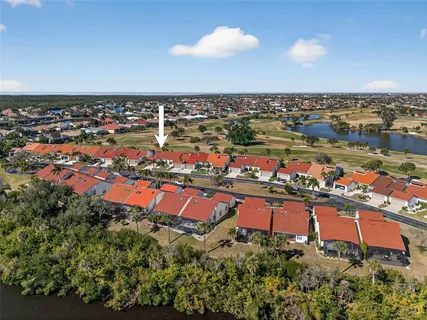 an aerial view of a houses with a swimming pool