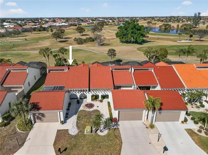an aerial view of residential houses with outdoor space and lake view