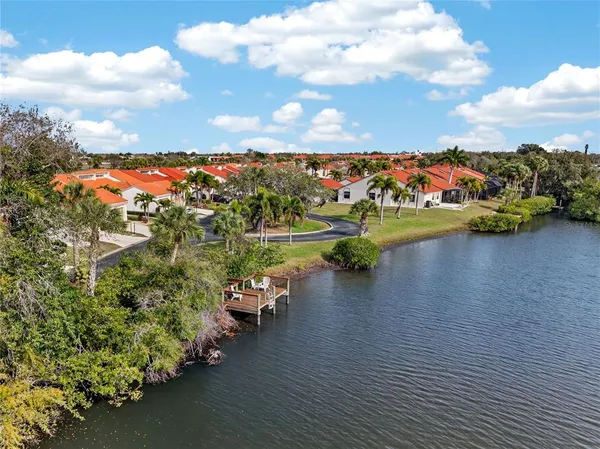 a view of a lake with houses in the back