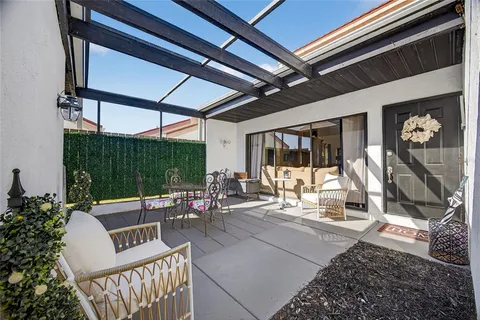 a building outdoor space with patio furniture and potted plants