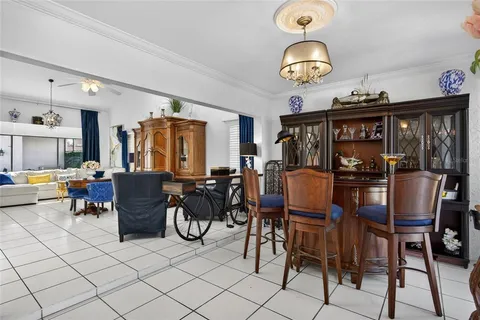 a view of a dining room with furniture and chandelier