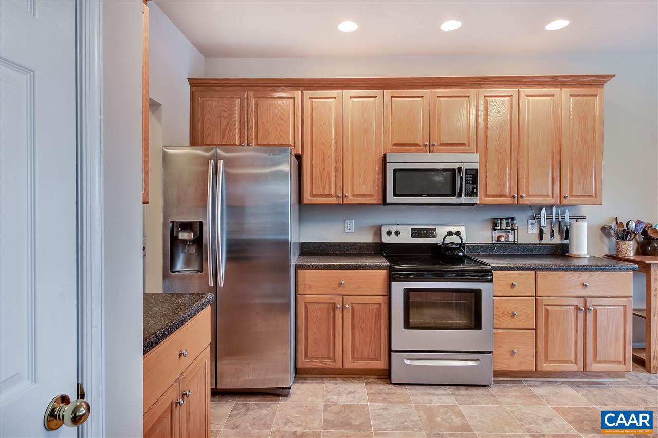 5875 Amicus Road Ruckersville, VA 22968 - Photo 11 of 31 a kitchen with stainless steel appliances granite countertop a stove a refrigerator and a microwave