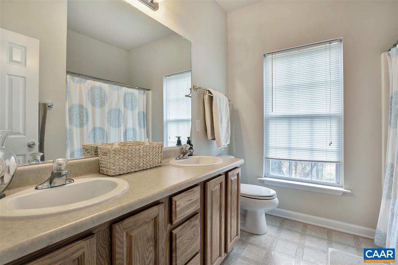 5875 Amicus Road Ruckersville, VA 22968 - Photo 17 of 31 a bathroom with a granite countertop sink toilet and mirror
