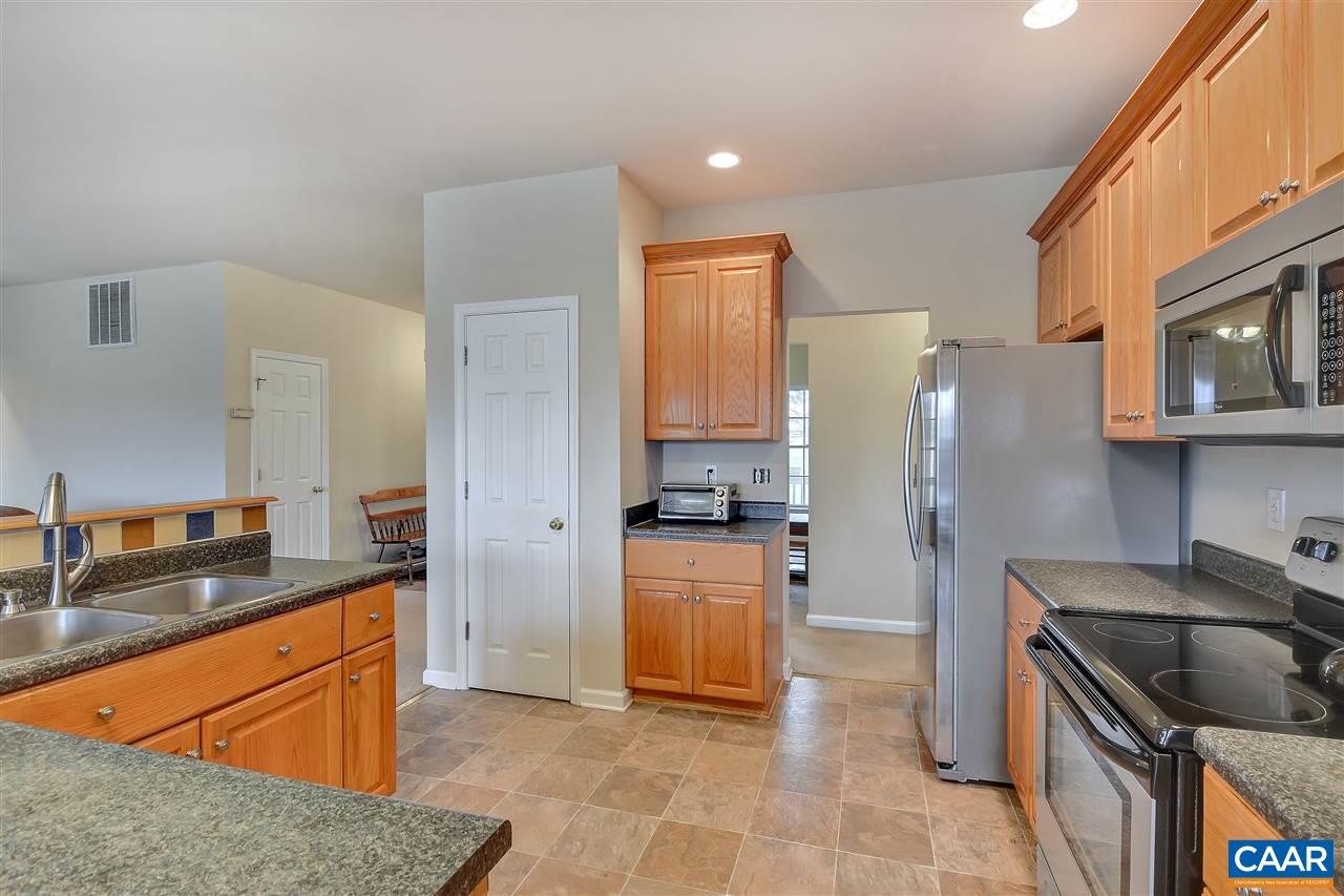 5875 Amicus Road Ruckersville, VA 22968 - Photo 8 of 31 a kitchen with stainless steel appliances granite countertop a sink stove and refrigerator