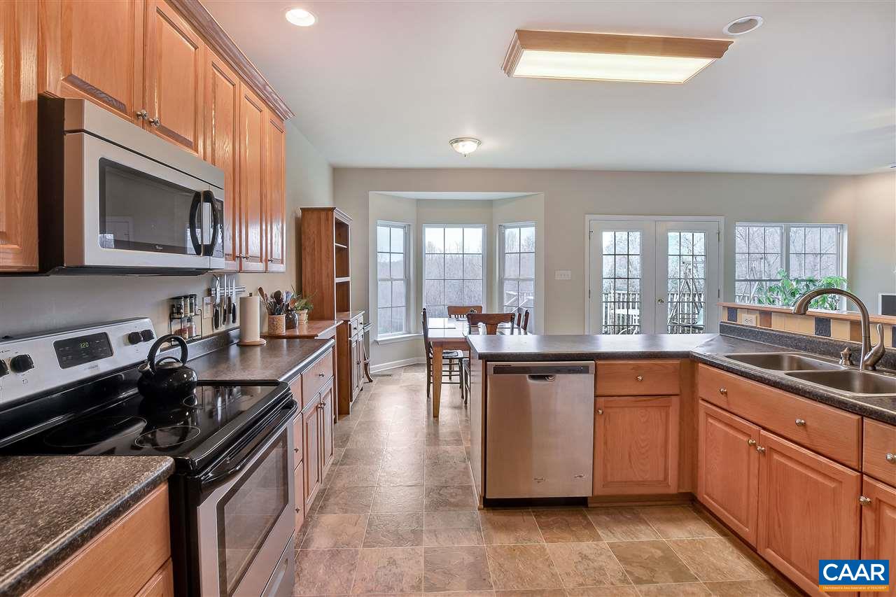 5875 Amicus Road Ruckersville, VA 22968 - Photo 10 of 31 a kitchen with stainless steel appliances granite countertop sink stove top oven and microwave