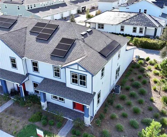an aerial view of a house with a yard