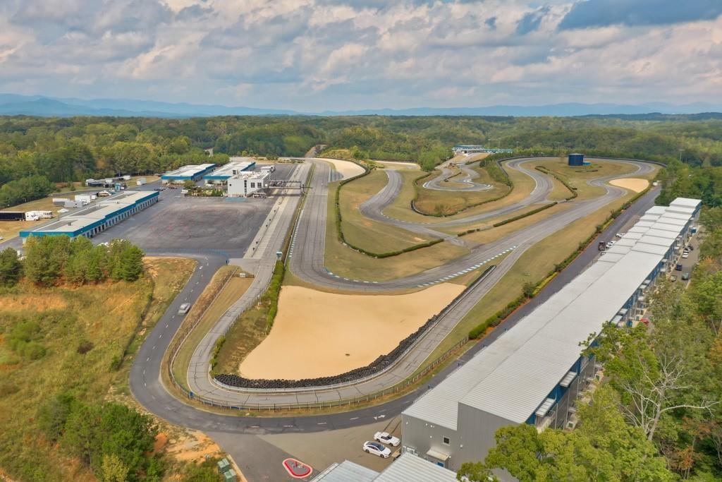 702 Joe Lane Cox Road, Unit 203 Dawsonville, GA 30534 - Photo 12 of 60 a view of a swimming pool with a lounge chair