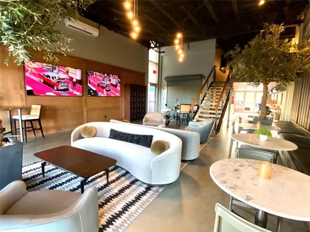 a living room with furniture and a pool table