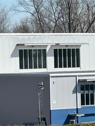 a view of a house with wooden fence