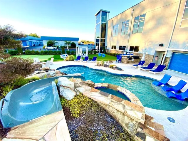 a view of yard with swimming pool and outdoor seating