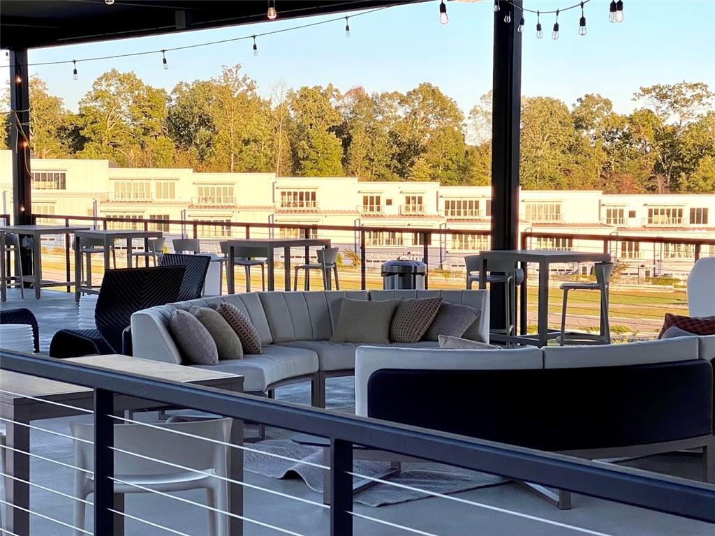 702 Joe Lane Cox Road, Unit 203 Dawsonville, GA 30534 - Photo 27 of 60 a view of a balcony with couches and wooden floor