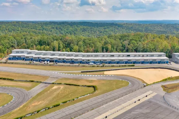 a view of a building with a yard and sitting area