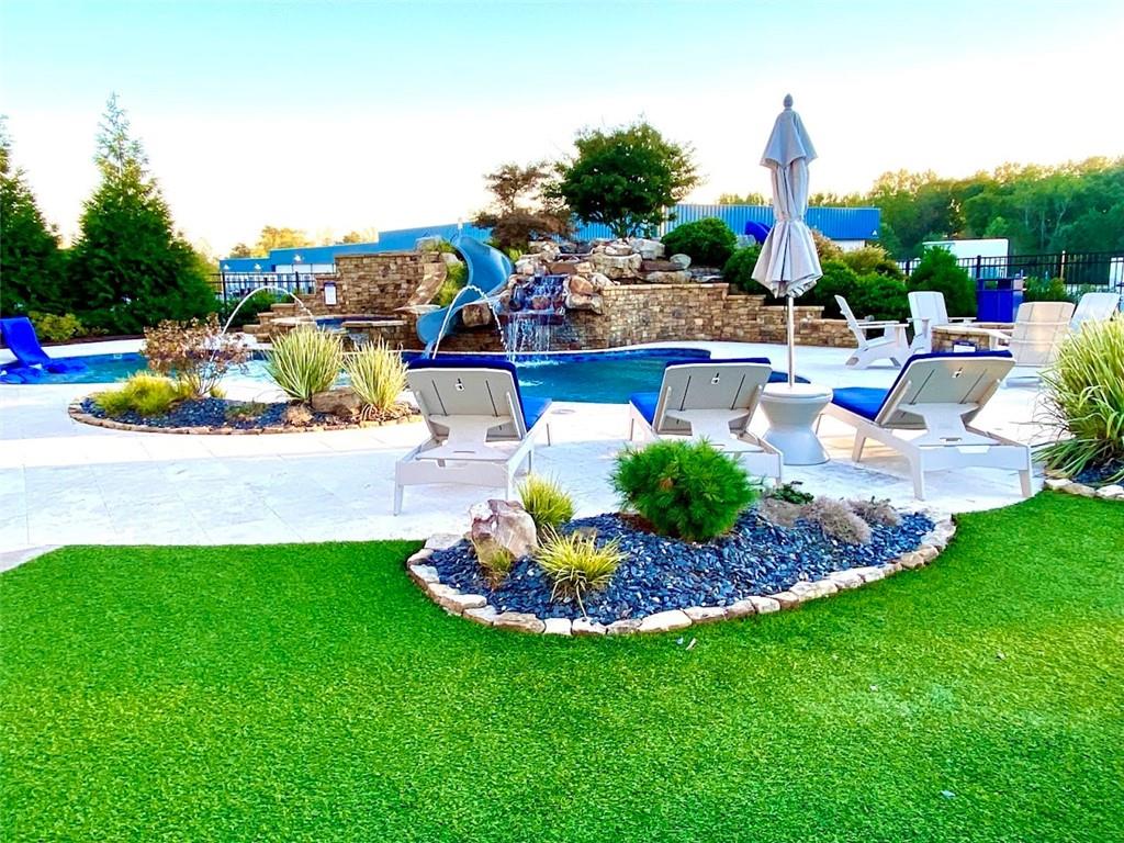 702 Joe Lane Cox Road, Unit 203 Dawsonville, GA 30534 - Photo 37 of 60 a view of a backyard with plants and patio