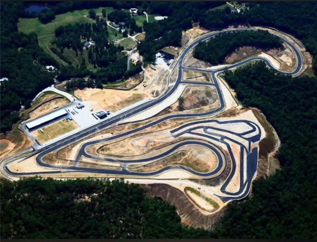 a view of water heater and car parked in a yard