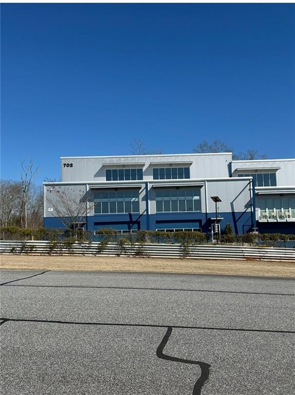 702 Joe Lane Cox Road, Unit 203 Dawsonville, GA 30534 - Photo 5 of 60 a view of a building with a yard and sitting area