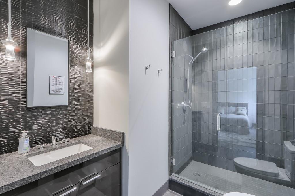 702 Joe Lane Cox Road, Unit 203 Dawsonville, GA 30534 - Photo 52 of 60 a bathroom with a granite countertop sink toilet and shower