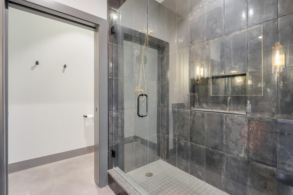 702 Joe Lane Cox Road, Unit 203 Dawsonville, GA 30534 - Photo 54 of 60 a bathroom with a glass shower door