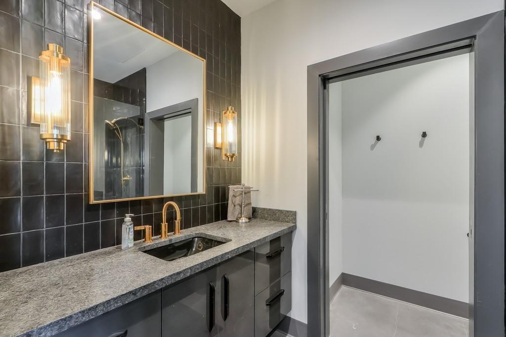 702 Joe Lane Cox Road, Unit 203 Dawsonville, GA 30534 - Photo 56 of 60 a bathroom with a granite countertop sink and a mirror