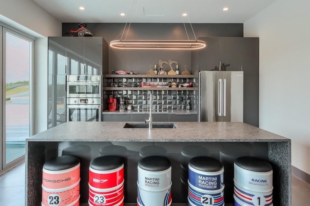 702 Joe Lane Cox Road, Unit 203 Dawsonville, GA 30534 - Photo 58 of 60 a kitchen with stainless steel appliances granite countertop a stove and a refrigerator