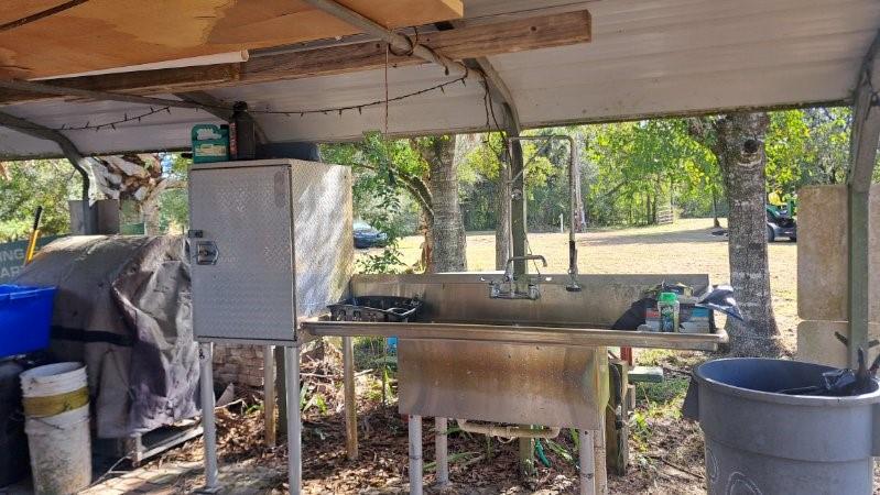 20327 Northwest 300th Street Okeechobee, FL 34972 - Photo 5 of 5 a roof deck with table and chairs and potted plants