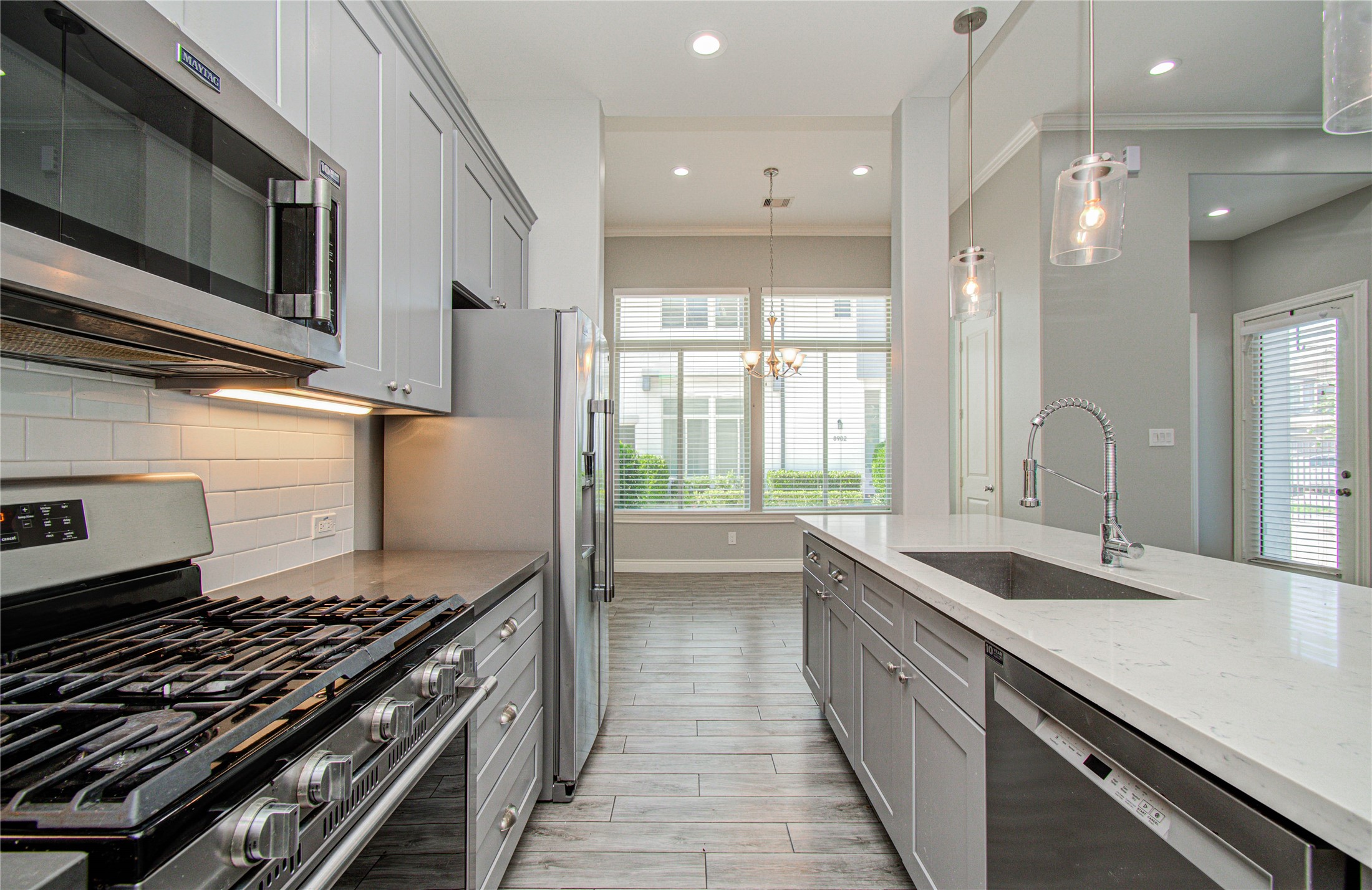 8903 Spring Knoll Forest Drive Houston, TX 77080 - Photo 9 of 29 a kitchen with stainless steel appliances granite countertop a sink and a stove