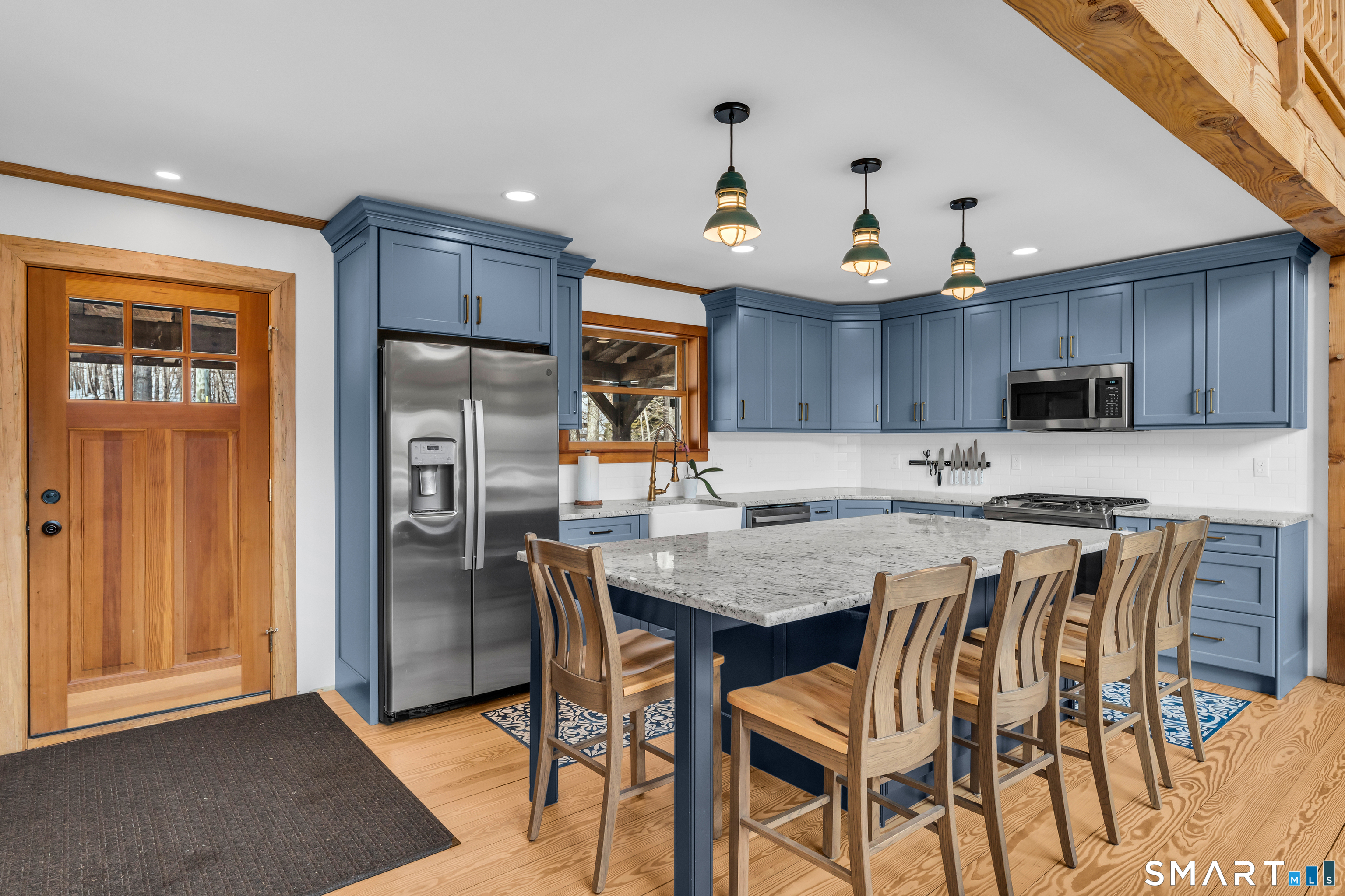 167 Round Hill Road Salem, CT 06420 - Photo 21 of 48 a kitchen with granite countertop a table chairs microwave and refrigerator
