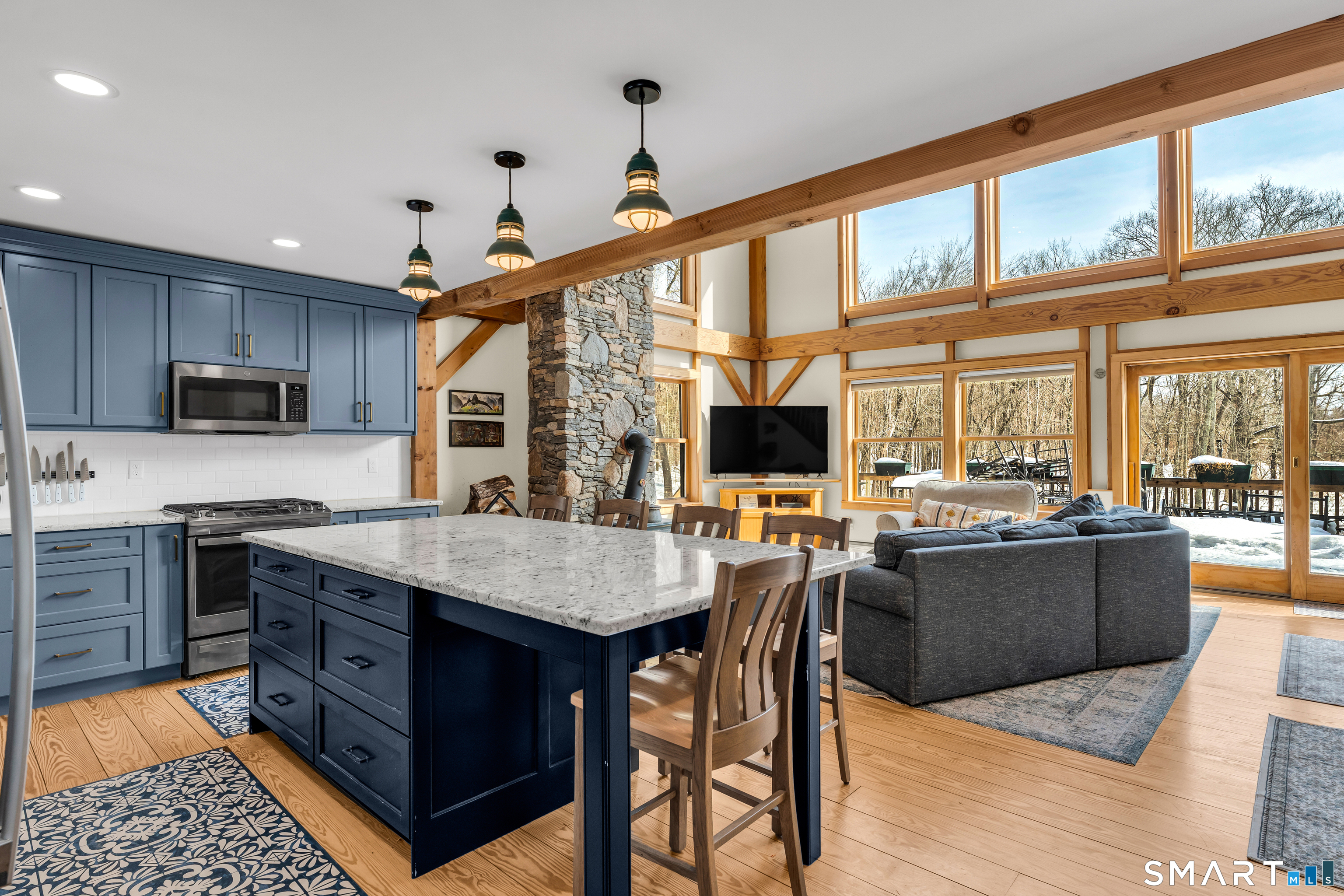 167 Round Hill Road Salem, CT 06420 - Photo 26 of 48 a kitchen with stainless steel appliances granite countertop a stove top oven a sink dishwasher a dining table and chairs with wooden floor