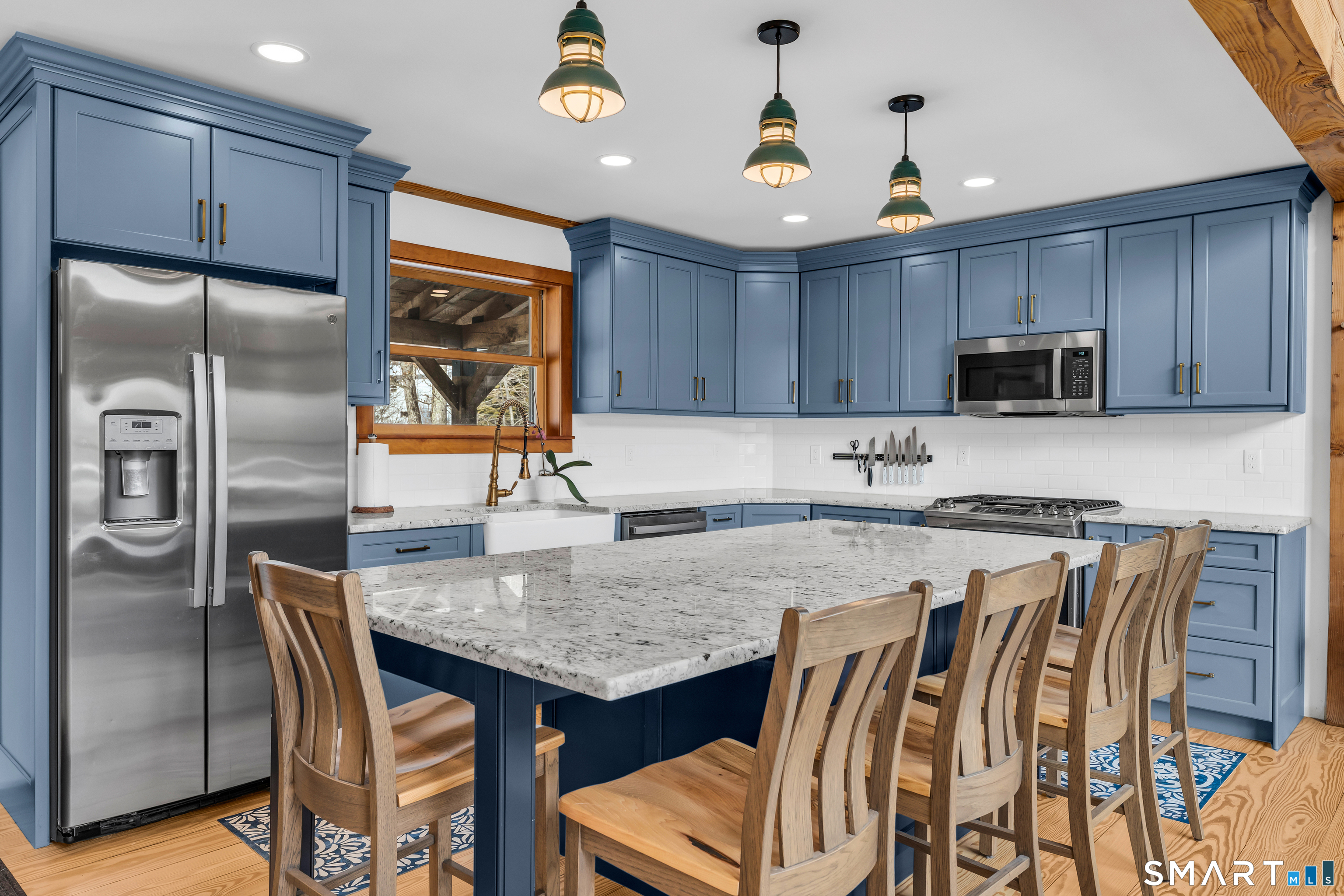 167 Round Hill Road Salem, CT 06420 - Photo 27 of 48 a kitchen with stainless steel appliances granite countertop a table chairs sink refrigerator and microwave