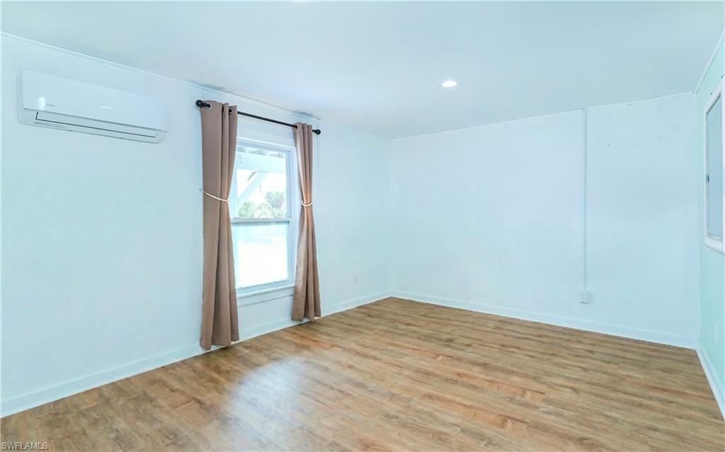 12277 Boat Shell Drive Matlacha Isles, FL 33991 - Photo 15 of 46 a view of empty room with wooden floor and fan