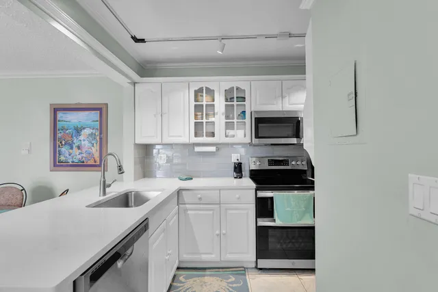 a kitchen with a sink stove and microwave