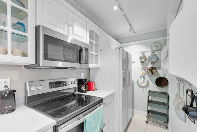 a kitchen with stainless steel appliances granite countertop a stove and a microwave