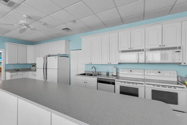 a room with pool table and windows