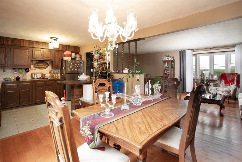 166 Stonehaven Road Fall River, MA 02723 - Photo 8 of 33 a dining room with furniture a chandelier and wooden floor