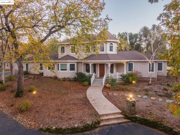 a front view of a house with yard porch and green space