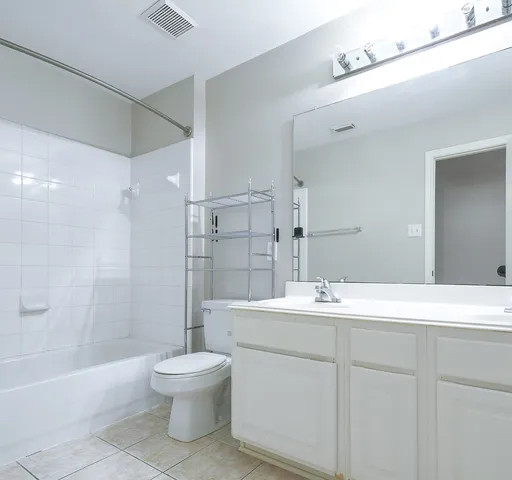 a bathroom with a sink toilet tub and shower
