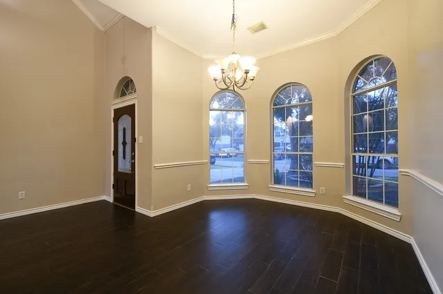 a view of room with window and wooden floor