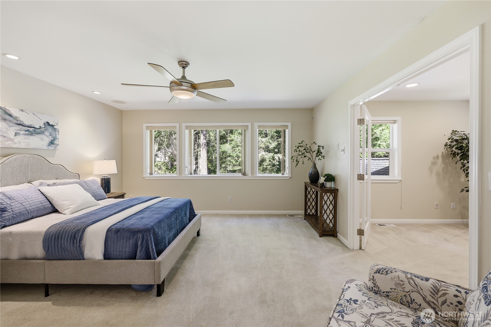 4354 Northwest Westgate Road Silverdale, WA 98383 - Photo 19 of 40 a spacious bedroom with a bed and a chandelier