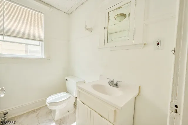 a white toilet sitting next to a bathroom sink