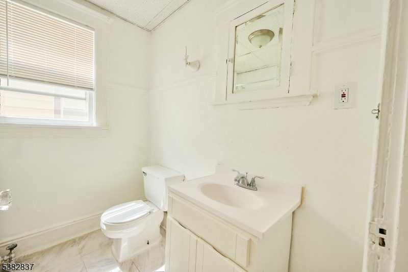 175 Madison Avenue, Unit 1 Elizabeth, NJ 07201 - Photo 7 of 10 a white toilet sitting next to a bathroom sink