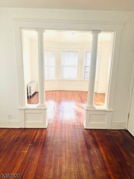 175 Madison Avenue, Unit 1 Elizabeth, NJ 07201 - Photo 9 of 10 an empty room with wooden floor and windows