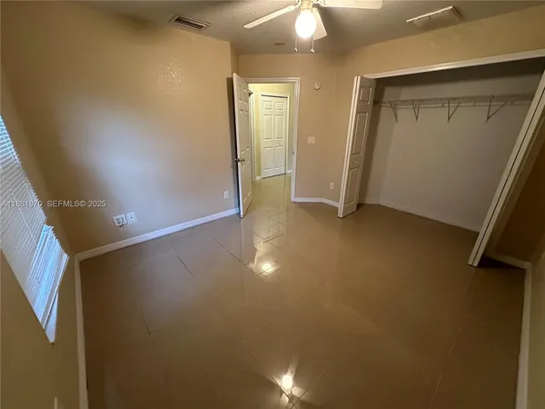 an empty room with a empty space and a window